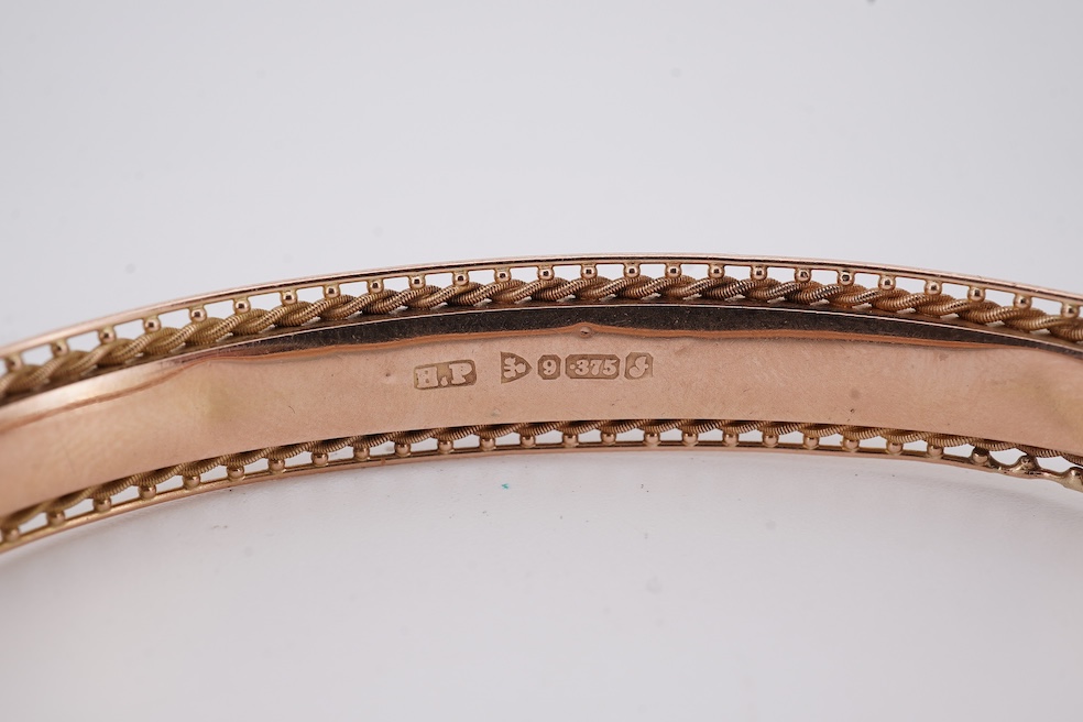 An Edwardian 9ct gold, sapphire and diamond set hinged bangle, Chester, 1909, interior diameter 57mm, gross weight 10 grams. Condition - poor